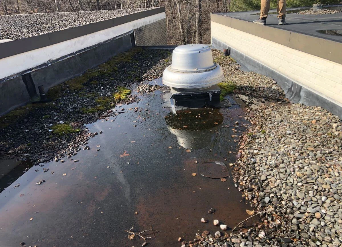 Ponding water on a commercial flat roof requiring emergency repair